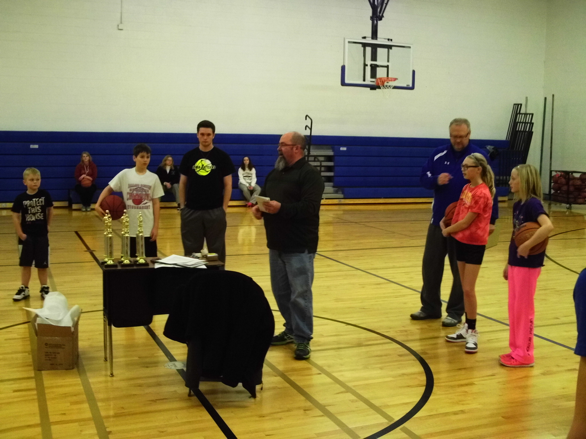 Perry Elk Mark McCarty, center, explains the ground rules to the young competitors in the 42nd annual Perry Elks Lodge Hoop Shoot.