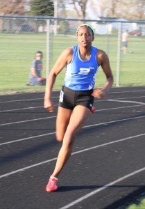 Johanna Diw sprints through the turn in the 200 dash at the Davis Relays. Diw was third in the 200 at the North Polk Co-ed Relays Tuesday in 28.18 seconds.
