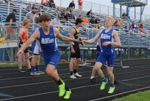 Jacob Thompson takes the baton from Zachary Thompson during the 4x800 in the Bluejay Relays at Kaufman Track Thursday.