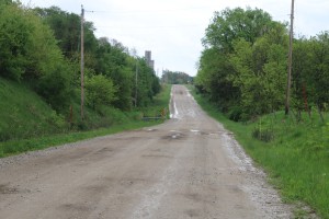 The stretch of 128th Place, the gravel road between U.S. Highway 169 and Bouton, would be costly to rebuild for use as a bike trail, engineers say.