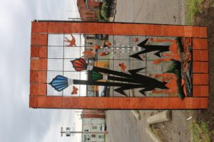 Perry's latest addition to public art is an Art on the Prairie-inspired panel featuring the Art on the Prairie logo surrounded by a border of clay tiles made by the public at last year's November art festival.