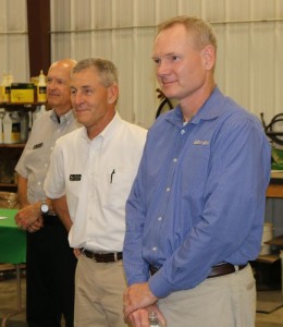 Don Van Houwelling, center, president of Van Wall Equipment near Perry, welcomed the governor and other figures from government and industry for the signing of the Connect Every Acre bill. Van Houwelling was joined by his son, Mike Van Houwelling, right, and Van Wall Equipment Territory Manager Norman Little.