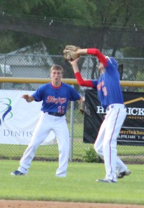 Shortstop Alex Long catches a pop fly in shallow left field as Kade Van Kirk pulls up on the play.
