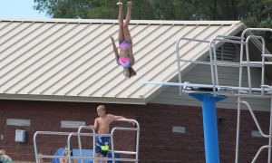 This young girl put on quite the show off the high board,, including this trip that started with her facing backward, doing a reverse somersault and completing a full twist before splashing down.
