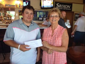 Nick Luett receives the winner's purse for the Championship Flight at the Memorial Tournament at the PG&CC Sunday from Patti Hayes Boyle, daughter of the late Gen Hayes, in whose honor this year's tourney was held.
