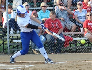 Rachel Kinney rips a base hit, one of her three singles in the game.