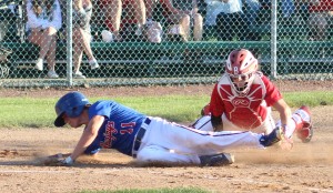Perry's Kade VanKirk slides safely around the tag of Boone catcher Nolan Newcomb to score in the third inning of their Class 3A District 4 Final in Boone Monday.
