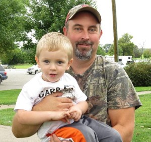 Mark Lee holds his son, Hudson, one of the children with cystic fibrosis helped by funds raised by the annual carp fishing tournament. Lee gave ThePerryNews.com permission to use his photograph.