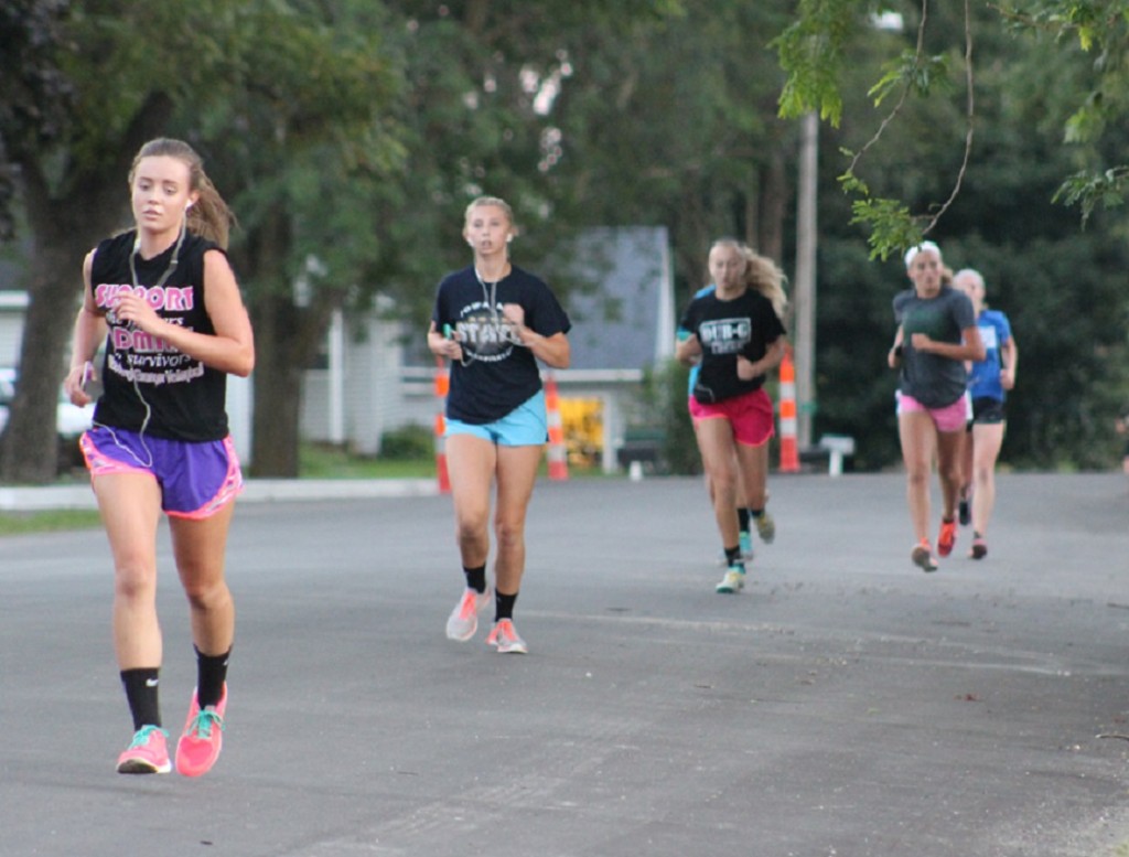 No, this is not a cross country team. It is a portion of the Woodward-Granger volleyball team, taking to the recently repaved streets of Woodward last week for a one-mile run, a standard part of their daily practices.