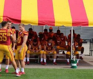 ISU players, including Seeley (29, at right) rest under a tent in the north end zone during Media Day.