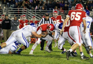 Boone quarterback Tanner Schminke takes a shot from Perry linebacker Mark Campos as he is pulled down from behind by defensive tackle Tyler Soll during their 2015 meeting.