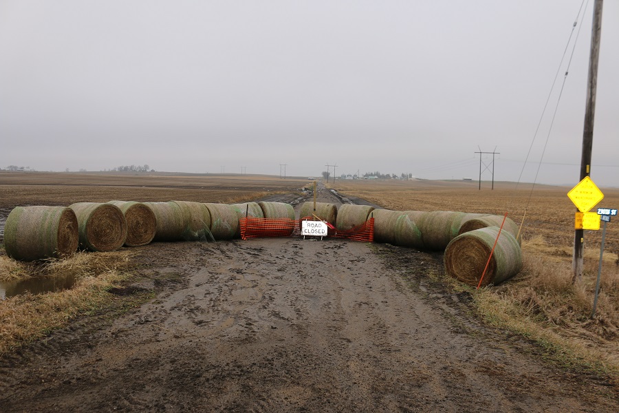 The intersection of X Avenue looking north from 230th Street shows the Level B roadway closed and blocked with hay bales.