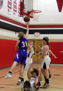 Perry junior Grace Marburger is fouled on her way to the basket by Greene County's Hannah Promes (falling).