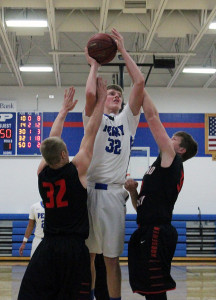 Perry senior Ryan Rathje shoots over Roland-Story defenders earlier this season.