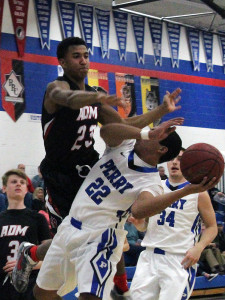 ADM's Cole Knoll defends against Perry's Shammond Ivory in the first quarter Tuesday. No foul was whistled on the play.