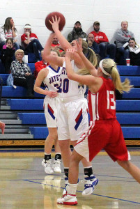 Perry sophomore guard Alyssa Kruger shoots as Ballard's Jenna Moody tries to interfere during Tuesday's Raccoon River Conference contest.