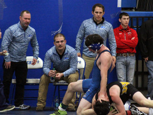 Perry's Troy Jahnke escapes WInterset's Josh Smith in their match at 152 pounds in Saturday's RRC tourney. Looking on are Perry volunteer coaches, from left, Nick Field, Drew Niebuhr and Mikel Hansen.