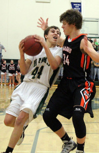 J.P. Nixon tries to get a shot off against the defense of visiting Madrid's Trevor Mertz Friday in Woodward.