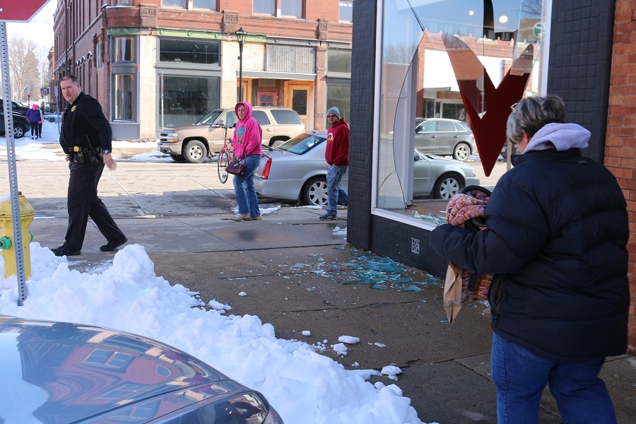 Perry Police Department Officer Wayne Schuttler kept passersby well away from the breakage at 1121 Second St., where a plate glass display window was broken Saturday afternoon.