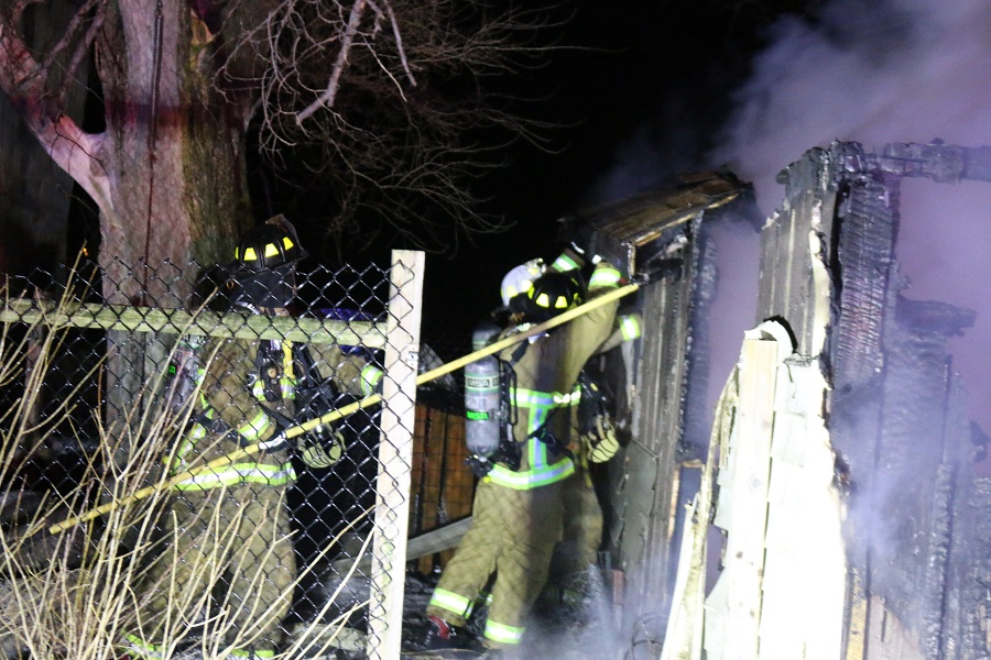 Adel and Redfield firefighters work to control a garage fire Thursday night near Redfield.