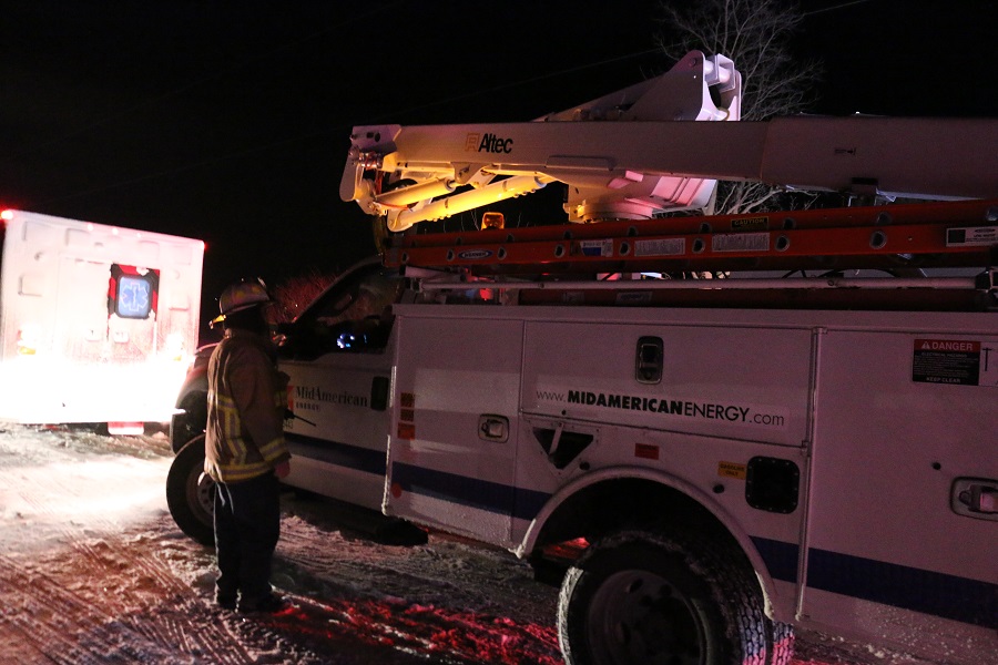 Adel Fire Chief Tim Morlan, left, consulted with a MidAmerican Energy crew who arrived about 10 p.m.