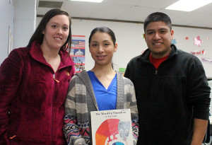 Laura Espinoza (middle) and PACES preschool team leader Cassandra Maldonado and PACES grade 3-4-5 team leader George Maldonado pose Tuesday in a classroom at the Perry Elementary School. Espinoza is leading a reading encouragement program for PACES students as part of her studies in the Latina Leadership Initiative.