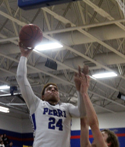 Perry's Janier Puente scores on a strong move to the basket against Boone Friday.