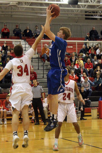 Perry's Ryan Rathje elevates to shoot over DC-G's Doug Heritage in their Class 3A District 15 Semifinal in Adel Monday.