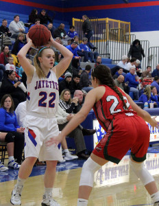 Perry senior Haileigh Kenyon looks over the Boone defense while be guarded by Rylee Claman Friday.