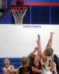Perry's Emma Olejniczak is whacked on the arm while shooting in the first quarter against Carroll Wednesday. Grace Marburger (left) and Taylor Lathrum (right) follow the shot for the Jayettes.