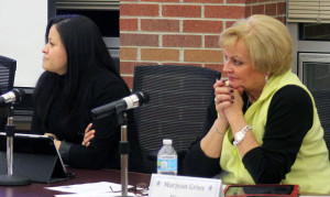 Perry School Board Directors Kenia Alarcon (left) and Marjean Gries listen to a report about school security during Monday's meeting.