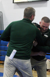 W-G senior Race Brant is mobbed by the Hawk coaches after his pin of second-ranked and previously undefeated Tommy Bradshaw of Greene County in the 152-pound sectional finals in Perry Saturday.