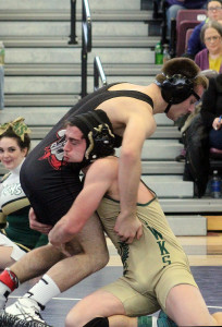 Race Brant of W-G lifts Dakota Henniger of Clarion-Goldfield-Dows in the 152-pound semis at the Webster City district tourney Saturday.
