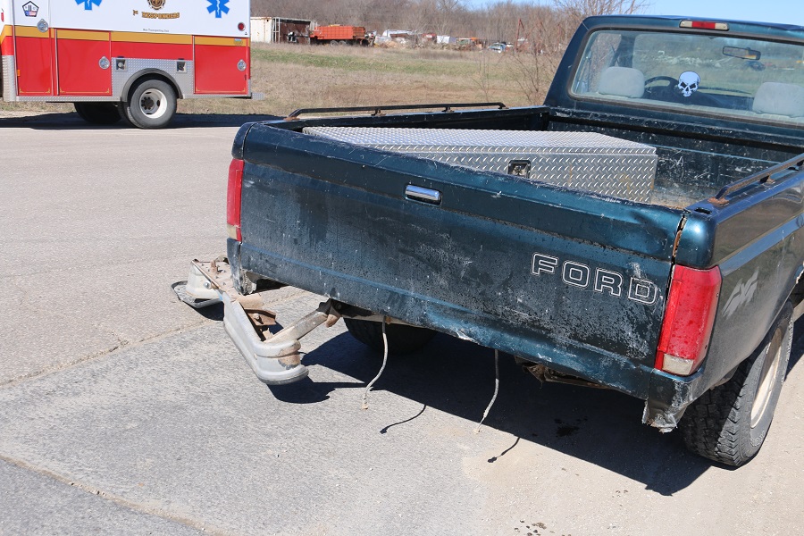 The Ford pickup had its rear bumper torn off in the collision.