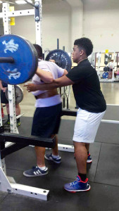 Gabe Cubillo is spotted by Tony Le as he performs a back squat during Perry's Lift-a-Thon Feb. 25. Photo by Scott Pierce.
