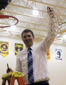 Ned Menke holds up the net after Perry defeated Glenwood in the Substate 8 Final at Atlantic March 1.