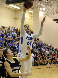 Perry post Janier Puente scores two of his 12 points after grabbing one of his 11 rebounds in the Bluejays' 73-71 overtime win against Glenwood in the Substate 8 Final Monday in Atlantic.
