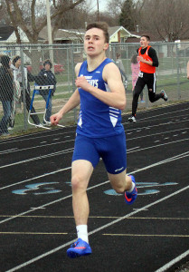 Reece Dunlap sneaks a peek at the clock as he enters the home stretch of the 400.