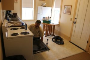 Mike Murphy, seasonal technician I with the Dallas County Conservation Department, did some last-minute detail work Friday on the new kitchen in the Dayton House. 