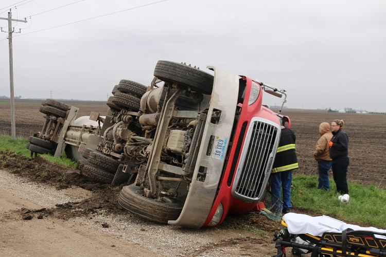 Emergency responders worked to free the driver from the cab of an overturned semi-tractor trailer Friday morning south of Dawson.