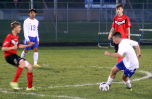 Perry's Alvaro Soto (13) looks on as James Crawford works the ball across midfield.