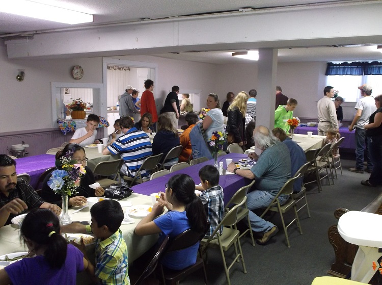 Community members enjoy a free meal at the monthly Meals fro the Heart event at the Perry Heartland Church of Christ.