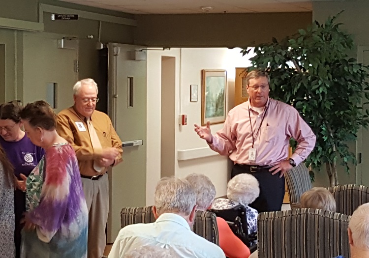 Rev. Max Phillips, right, praised Dr. Randy McCaulley at a farewell party Friday at the Perry Lutheran Home Main Campus.