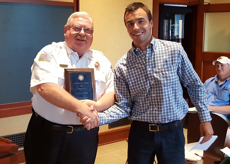 Perry Volunteer Fire Department Chief Chris Hinds, left, was awarded the 2016 Perry Civil Servant of the Year Award Monday by Perry Rotary Club President Quinn Adair.
