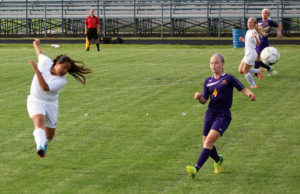 Perry defender Joselyn Perla blasts the ball back up the pitch against Denison-Schleswig Tuesday.