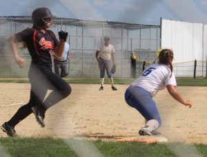 Jayette first baseman Maddie West stretches for the throw from shortstop Jo Diw, who ranged far to her right, planted, and gunned down this Comet batter.