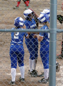 Jo Diw beams as she is greeted by teammates Brooke Huntington (2), Maddy Jans (right) and Emma Olejniczak (right, rear) after driving all in with a grand slam in the sixth inning against Greene County Thursday.