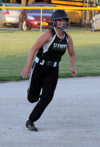 Carli Major is all smiles as she advances from first base to third on Riley Jamison's double in the fifth inning.