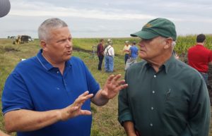 Iowa Department of Agriculture and Land Stewardship Secretary Bill Northey, left, talks with Dallas County Soil and Water District Commissioner Ray Harden and others at Friday's tour of the saturated buffer at the farm of Tom Vincent near Perry.