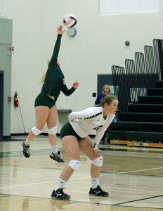 W-G libero player Kara Bodensteiner serves as Kaycee Major waits during against visiting WCV Aug. 30. Bodensteiner had six aces in four matches Saturday.
